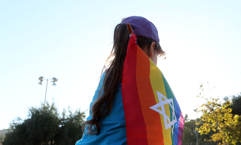 A Young Person with a Pride Flag